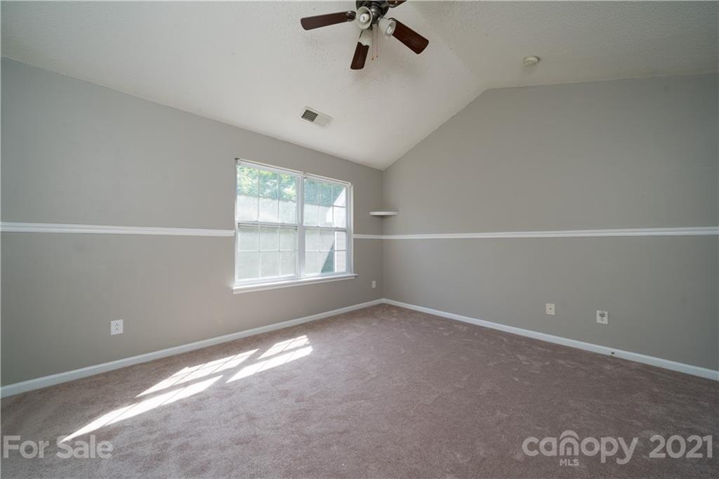 11329 Stone Trail Road Charlotte, NC 28213 - Photo 19 of 23 an empty room with windows and ceiling fan