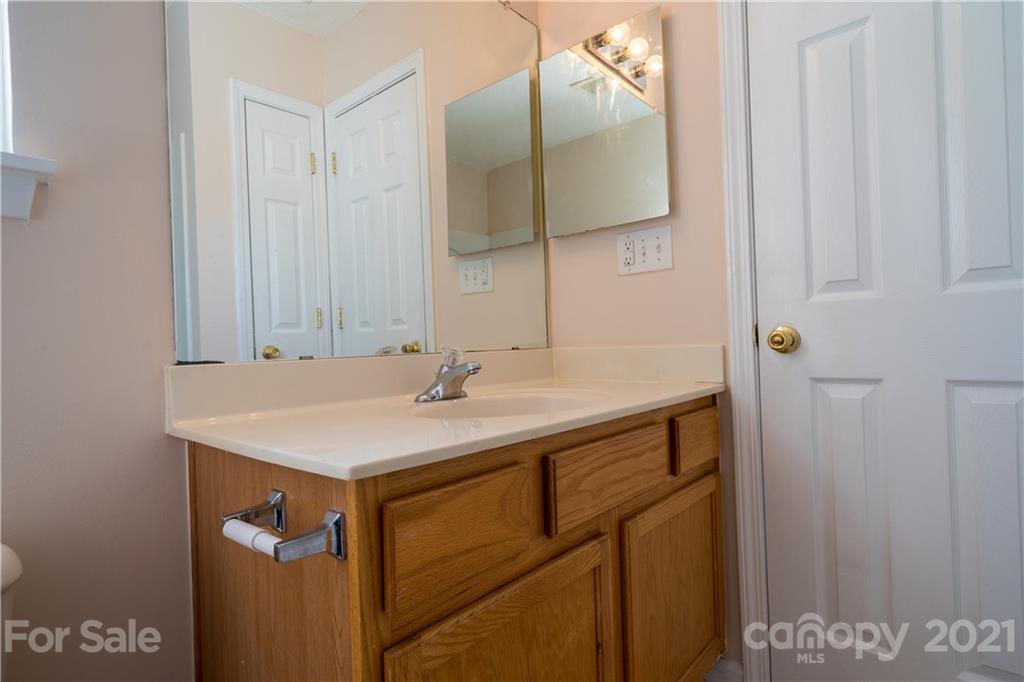 11329 Stone Trail Road Charlotte, NC 28213 - Photo 22 of 23 a bathroom with a sink and a mirror