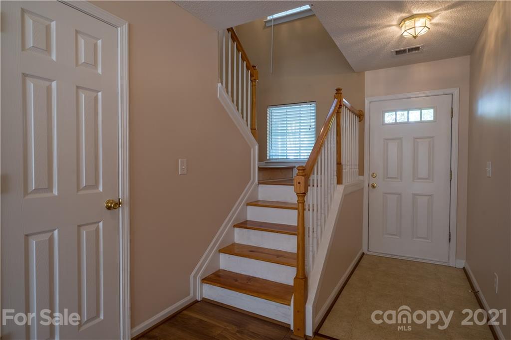 11329 Stone Trail Road Charlotte, NC 28213 - Photo 4 of 23 a view of entryway with stairs and wooden floor
