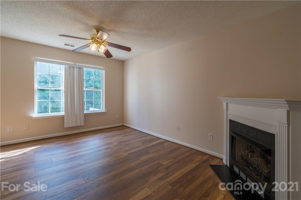 11329 Stone Trail Road Charlotte, NC 28213 - Photo 5 of 23 a view of an empty room with wooden floor fireplace and a window