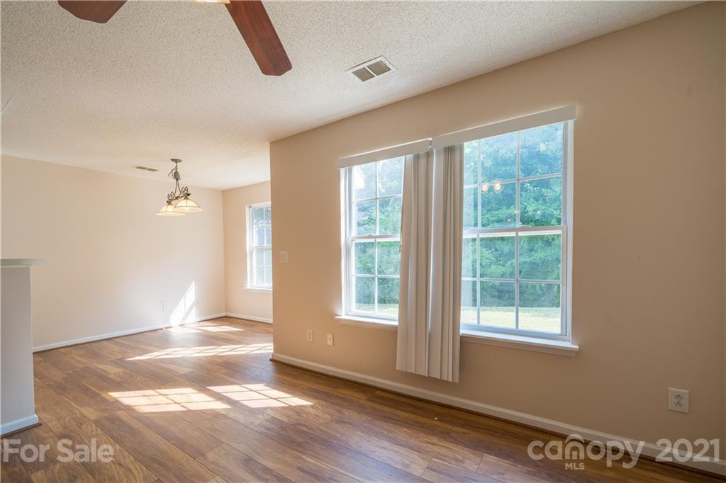 11329 Stone Trail Road Charlotte, NC 28213 - Photo 6 of 23 a view of an empty room with wooden floor and a window
