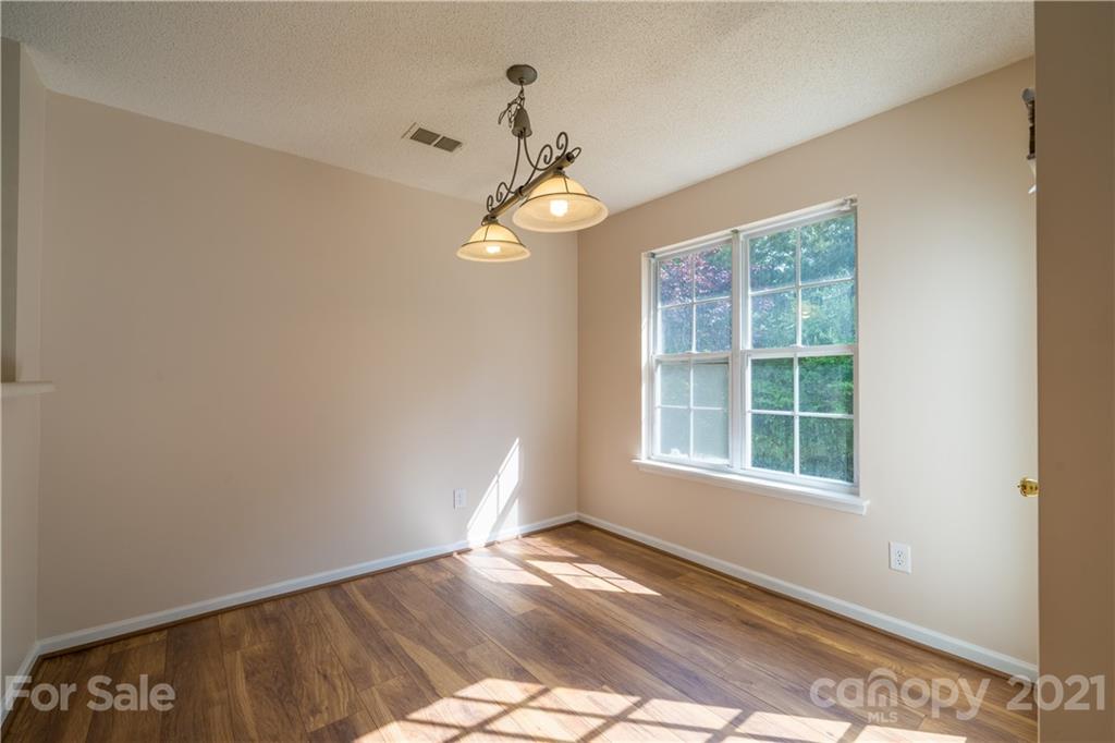 11329 Stone Trail Road Charlotte, NC 28213 - Photo 7 of 23 a view of an empty room with wooden floor and a window