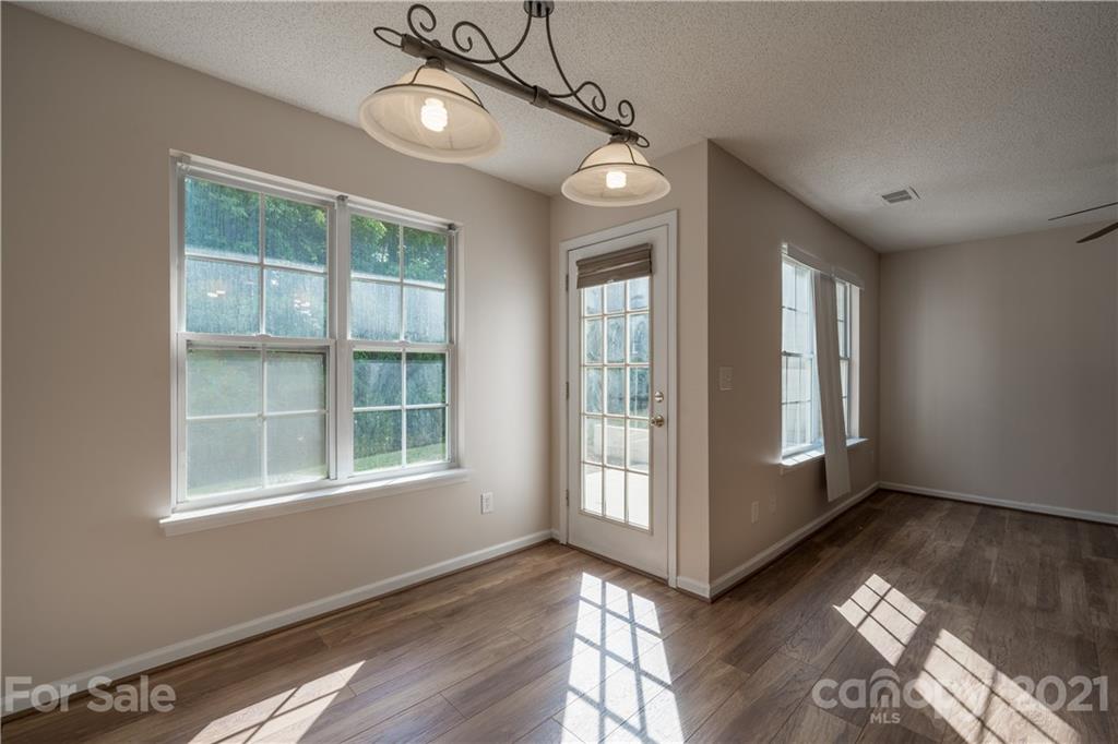 11329 Stone Trail Road Charlotte, NC 28213 - Photo 8 of 23 a view of an empty room with wooden floor and a window