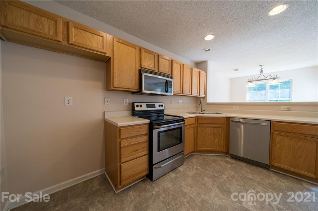 11329 Stone Trail Road Charlotte, NC 28213 - Photo 9 of 23 a kitchen with stainless steel appliances granite countertop a stove a sink dishwasher and a microwave oven with cabinets