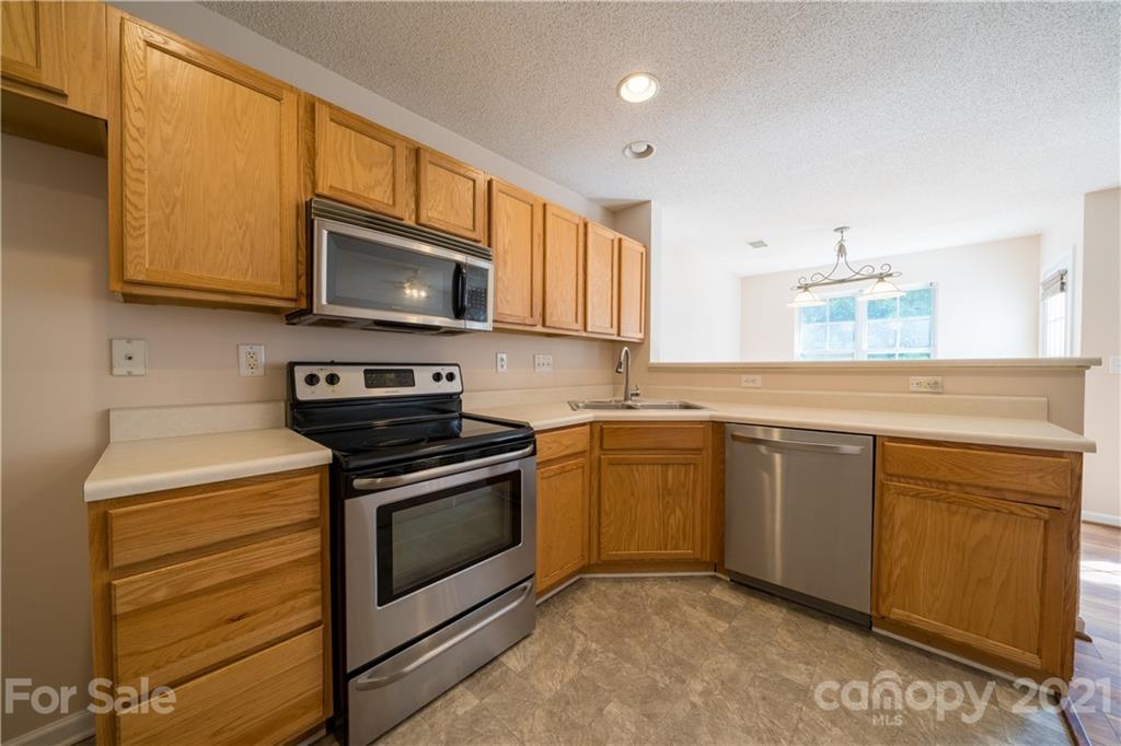 11329 Stone Trail Road Charlotte, NC 28213 - Photo 10 of 23 a kitchen with stainless steel appliances granite countertop a stove and a microwave