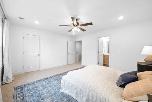 940 Britton Springs Road, Unit 604 Clarksville, TN 37042 - Photo 21 of 30 a bedroom with a bed and a ceiling fan