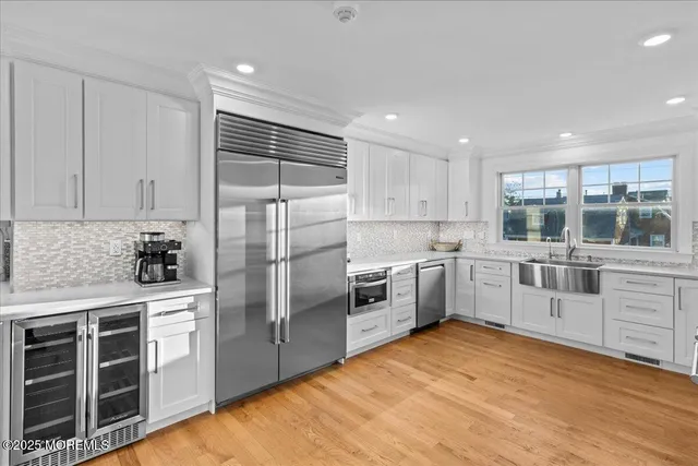 a kitchen with white cabinets and white appliances