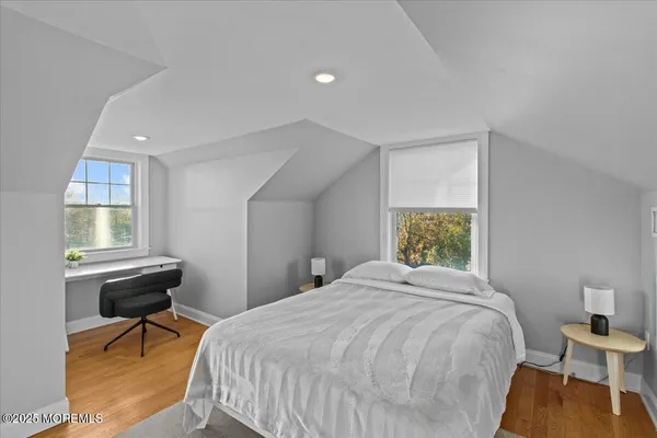 a bedroom with a bed and painting on the wall