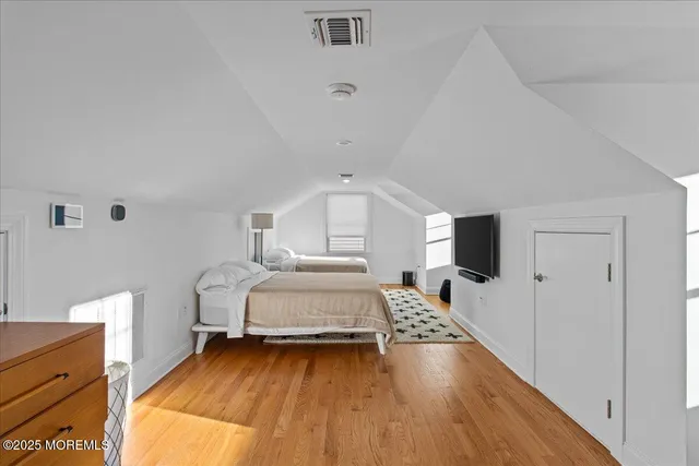 a bedroom with a bed and a night stand