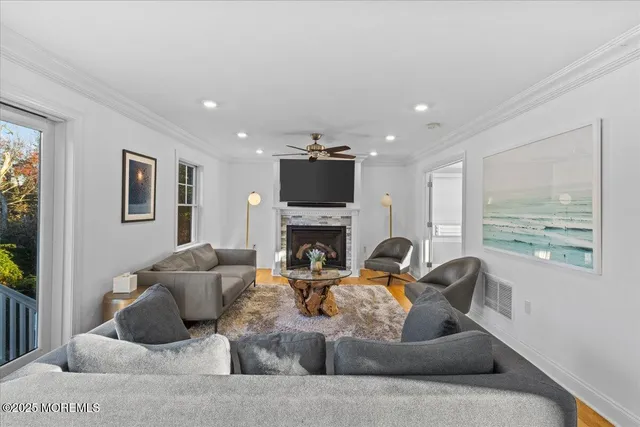 a living room with furniture a large window and a fireplace