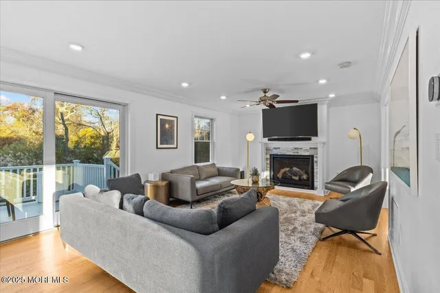 a living room with furniture a fireplace and a flat screen tv