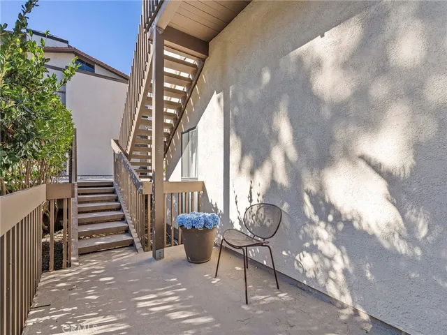 a view of a porch with a table and chairs