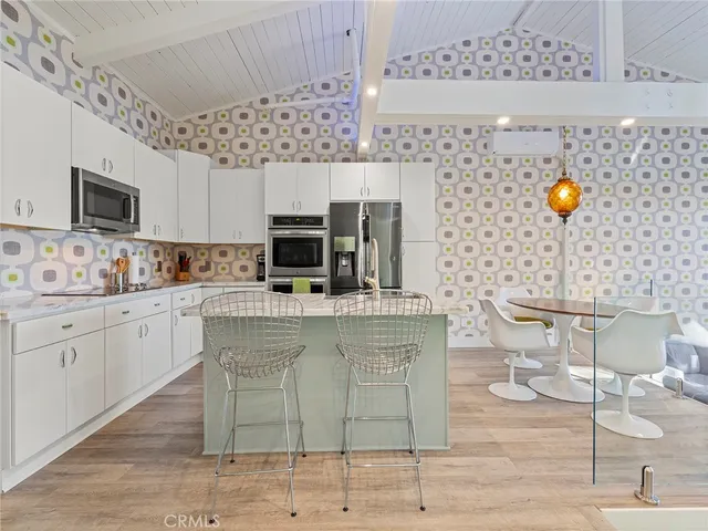 a kitchen with stainless steel appliances a stove refrigerator sink and microwave