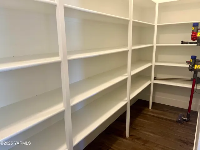 a view of walk in closet with empty racks