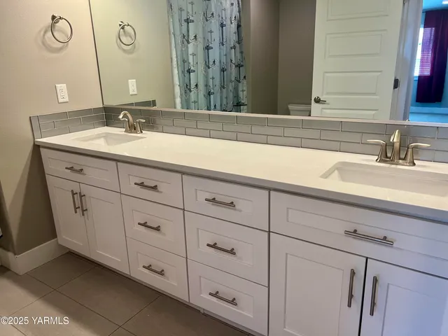 a bathroom with a toilet and a shower curtain