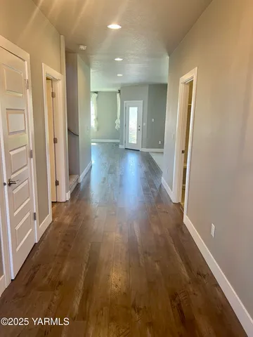 a view of a hallway with wooden floor
