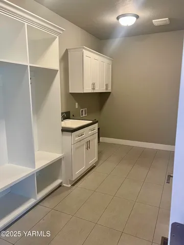 a view of a kitchen with white cabinets