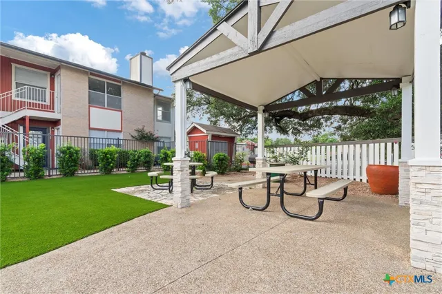 a view of a patio with a table and chairs