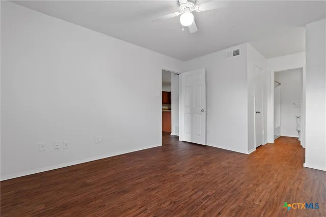 a view of livingroom with hardwood floor and ceiling fan