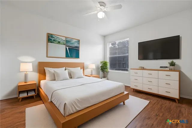 a bedroom with a bed and a flat screen tv