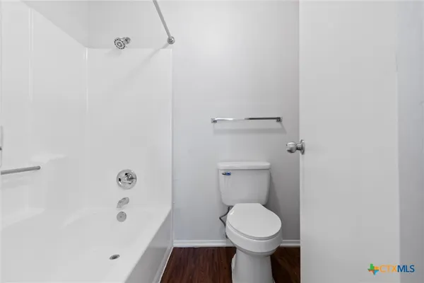 a bathroom with a toilet and a bathtub