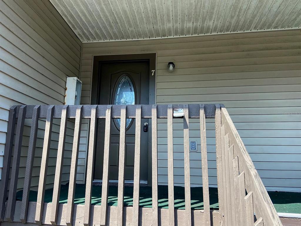 12065 Proctor Loop, Unit 7 New Port Richey, FL 34654 - Photo 2 of 6 a view of wooden house with a door