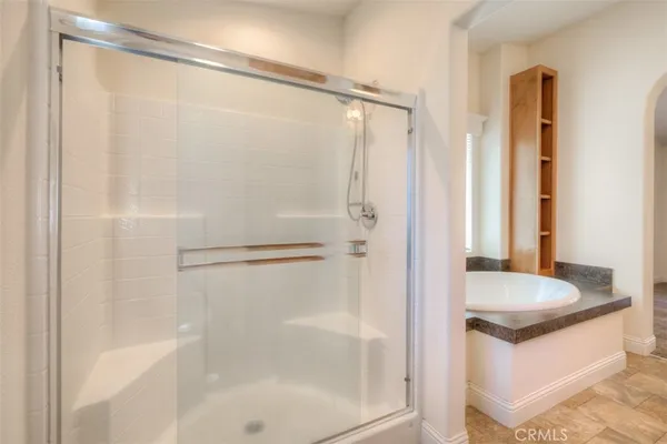 a bathroom with a granite countertop shower and a sink