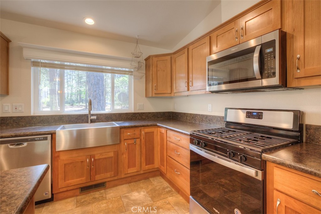 14565 Coutolenc Road Magalia, CA 95954 - Photo 2 of 43 a kitchen with stainless steel appliances granite countertop a stove a sink and a microwave
