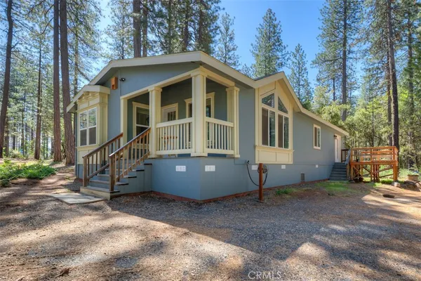 a view of a house with a yard and wooden fence