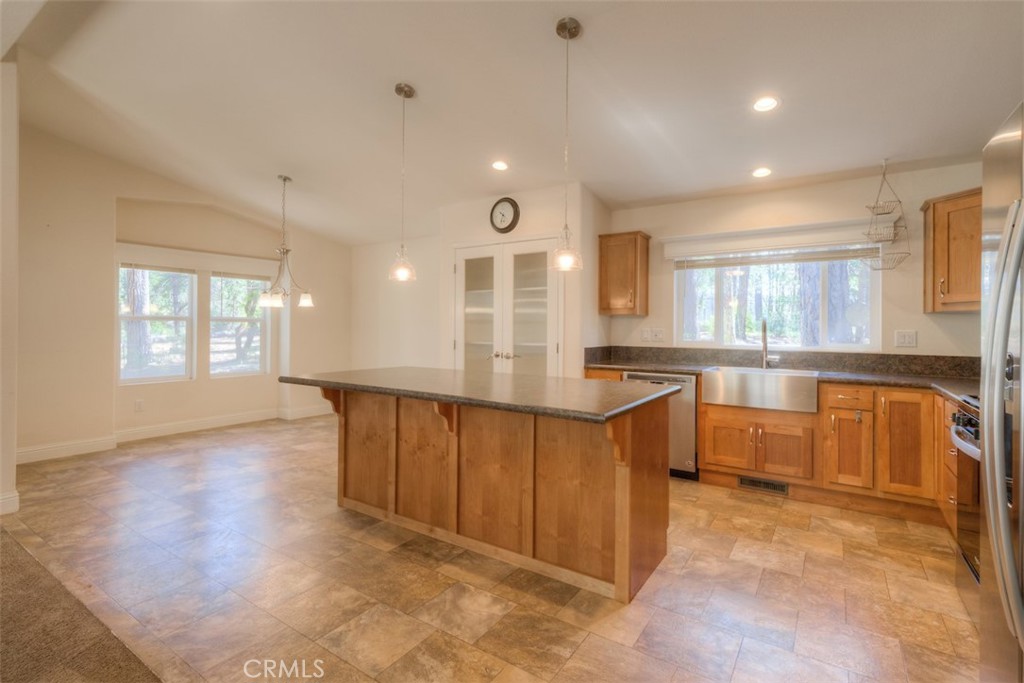 14565 Coutolenc Road Magalia, CA 95954 - Photo 4 of 43 a large kitchen with kitchen island white cabinets and wooden floor