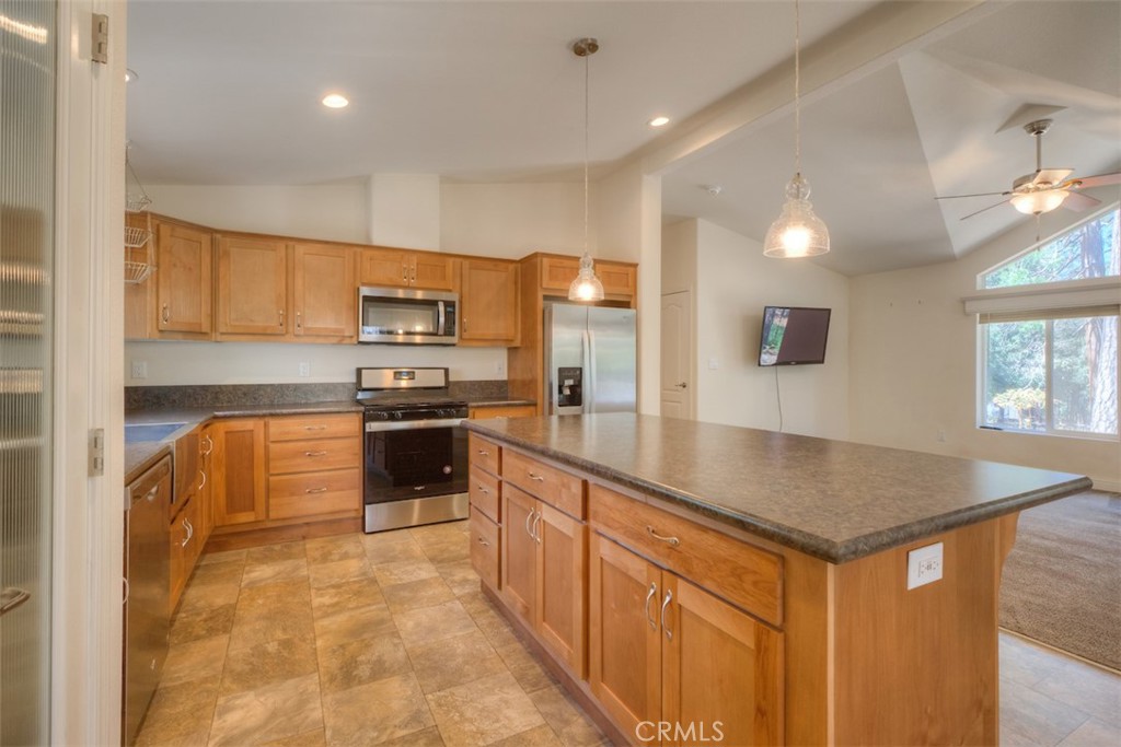 14565 Coutolenc Road Magalia, CA 95954 - Photo 6 of 43 a kitchen with stainless steel appliances granite countertop a stove a sink and a refrigerator