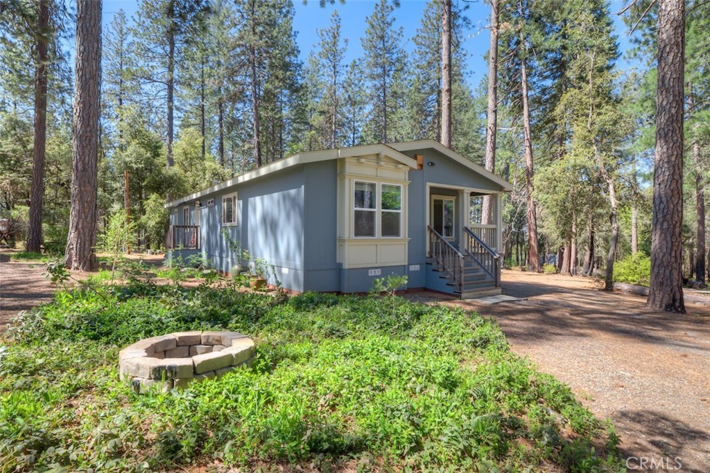 14565 Coutolenc Road Magalia, CA 95954 - Photo 8 of 43 a view of a house with a yard and large trees