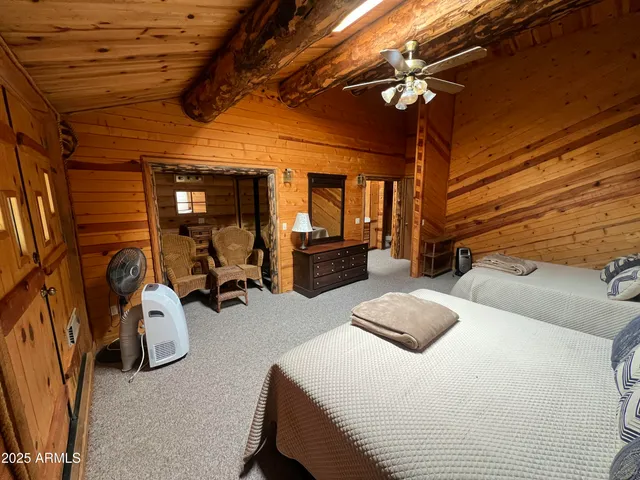 a bedroom with bed and a chandelier