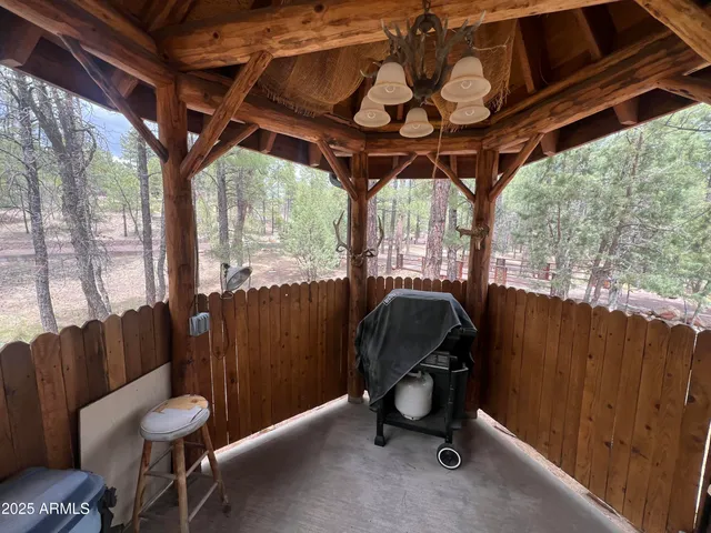 a view of a chair and tables in the back yard
