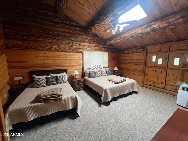 a bedroom with bed and a chandelier