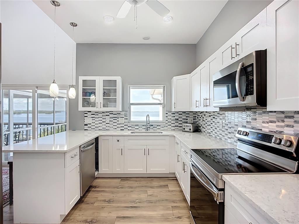 2424 69th Avenue West, Unit 2424 Bradenton, FL 34207 - Photo 12 of 49 a kitchen with stainless steel appliances granite countertop a stove and a sink