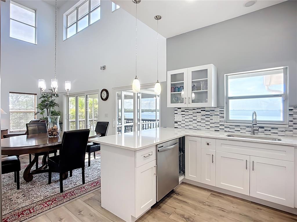 2424 69th Avenue West, Unit 2424 Bradenton, FL 34207 - Photo 14 of 49 a kitchen with cabinets table and chairs