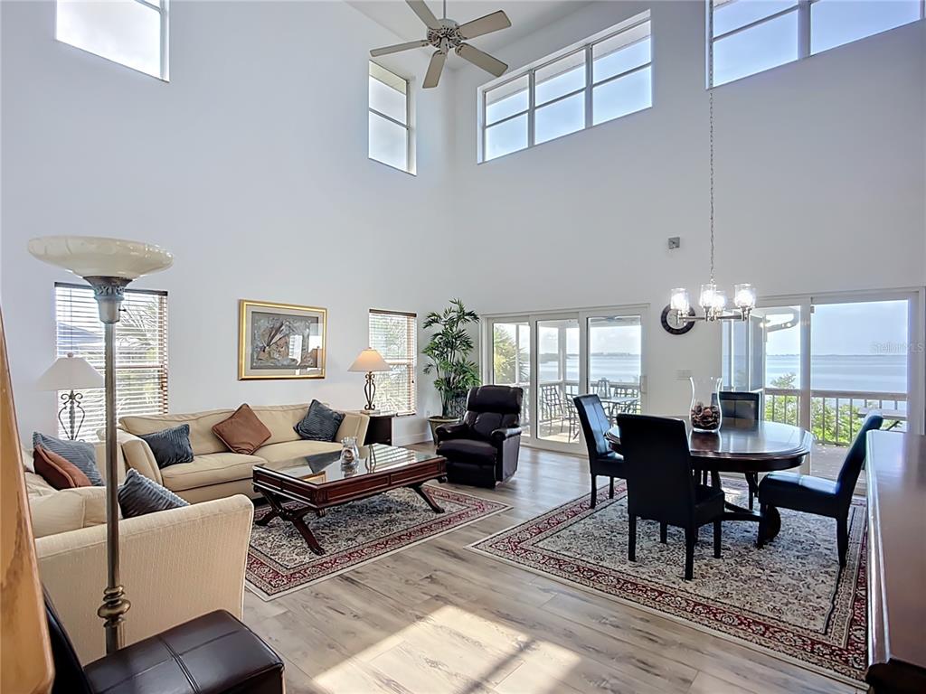 2424 69th Avenue West, Unit 2424 Bradenton, FL 34207 - Photo 2 of 49 a living room with furniture and a chandelier