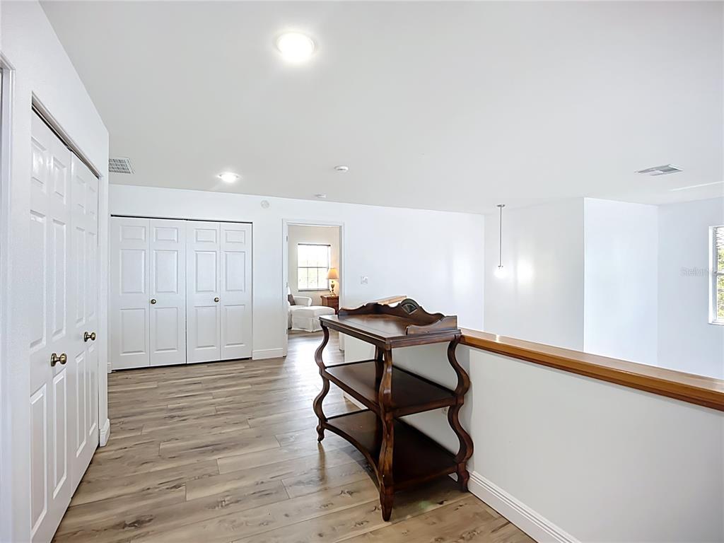 2424 69th Avenue West, Unit 2424 Bradenton, FL 34207 - Photo 23 of 49 a view of a room with wooden floor and bench