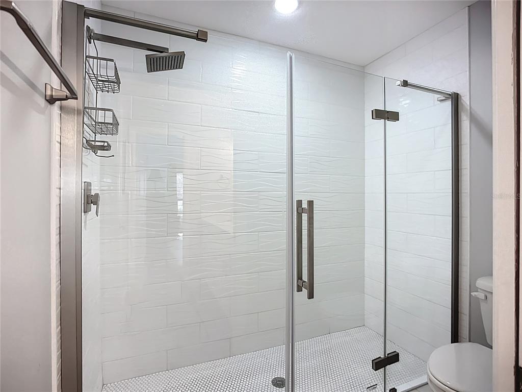 2424 69th Avenue West, Unit 2424 Bradenton, FL 34207 - Photo 27 of 49 a bathroom with a shower and toilet