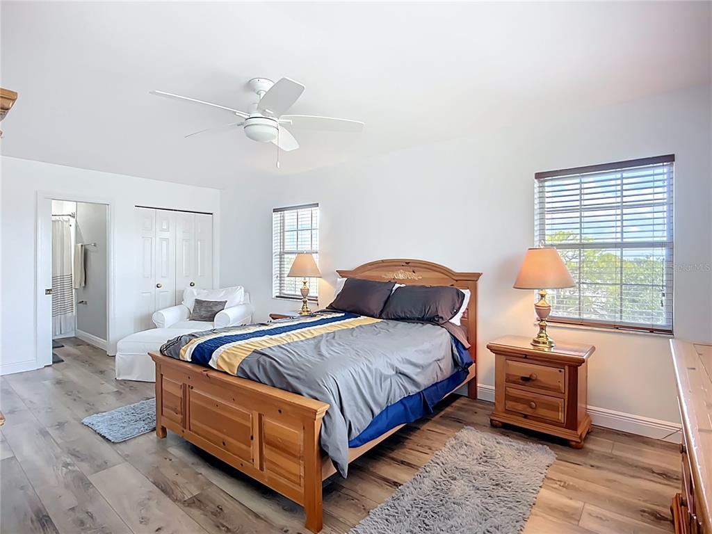 2424 69th Avenue West, Unit 2424 Bradenton, FL 34207 - Photo 30 of 49 a bedroom with a bed and wooden floor