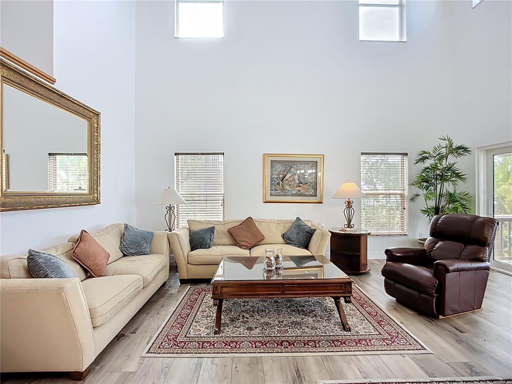2424 69th Avenue West, Unit 2424 Bradenton, FL 34207 - Photo 4 of 49 a living room with furniture a rug and a window