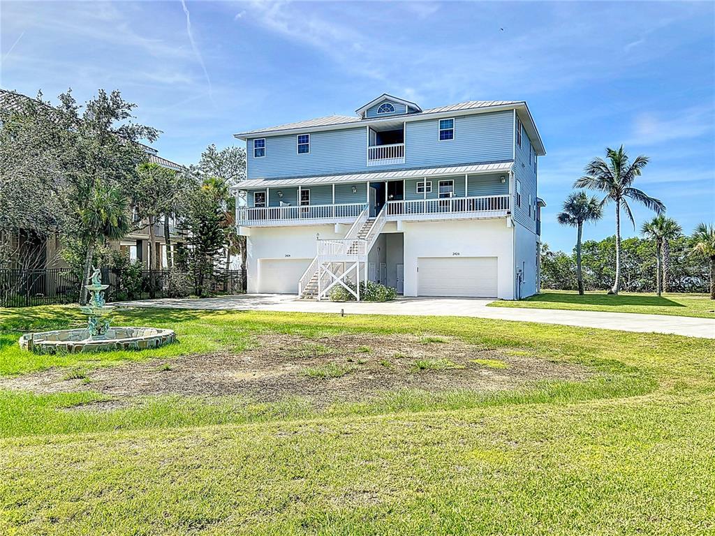2424 69th Avenue West, Unit 2424 Bradenton, FL 34207 - Photo 41 of 49 a view of a house with a swimming pool and a yard