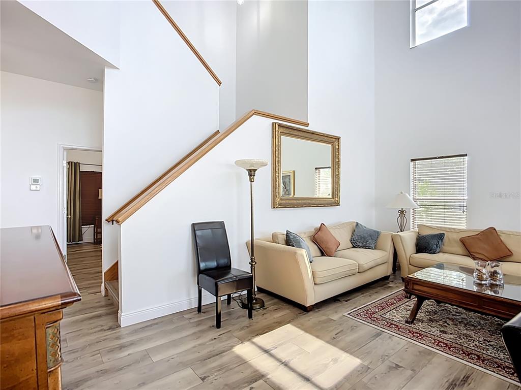 2424 69th Avenue West, Unit 2424 Bradenton, FL 34207 - Photo 5 of 49 a living room with furniture and a wooden floor