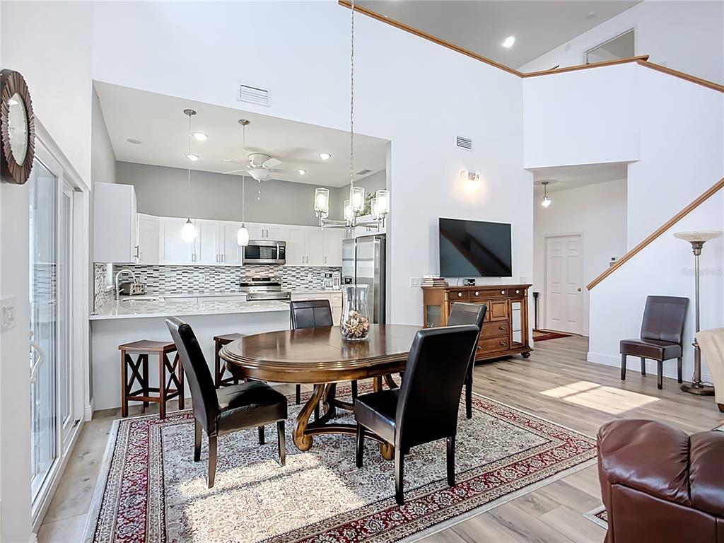 2424 69th Avenue West, Unit 2424 Bradenton, FL 34207 - Photo 8 of 49 a dining room with furniture and kitchen view