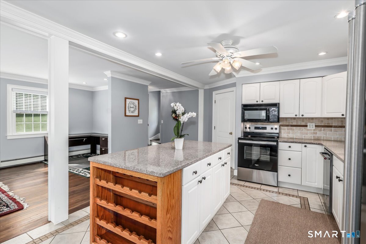 19 Botsford Hill Road Newtown, CT 06470 - Photo 9 of 40 a kitchen with kitchen island granite countertop appliances cabinets and a counter top space