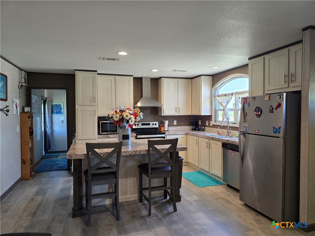 412 Coryell City Road Gatesville, TX 76528 - Photo 6 of 34 a kitchen with a refrigerator a dining table and chairs