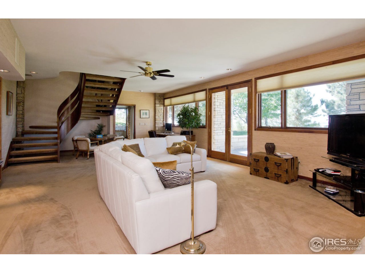 8818 West Phillips Road Boulder, CO 80301 - Photo 18 of 25 a living room with furniture and a flat screen tv
