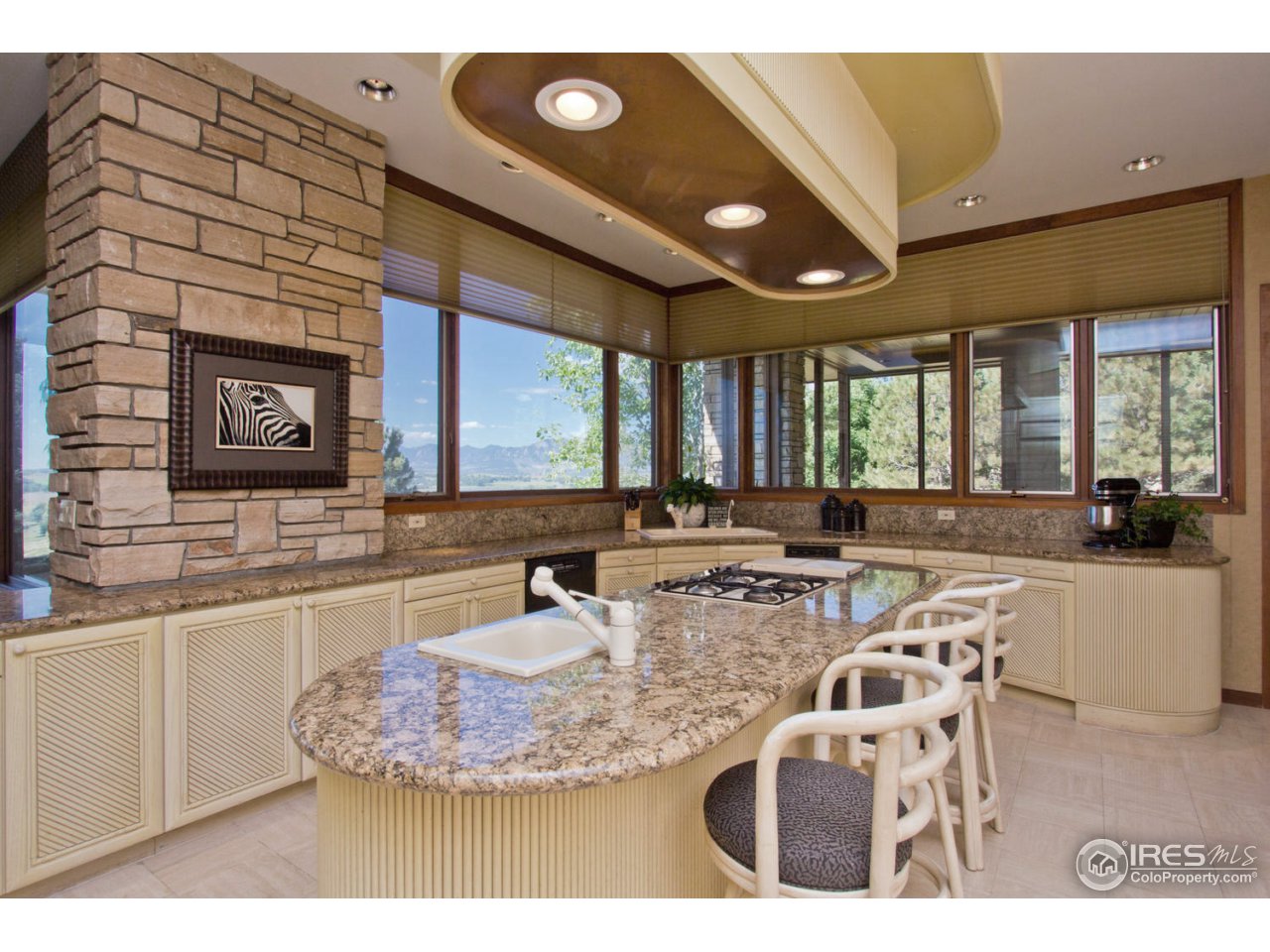8818 West Phillips Road Boulder, CO 80301 - Photo 10 of 25 a kitchen with kitchen island granite countertop a sink cabinets and window