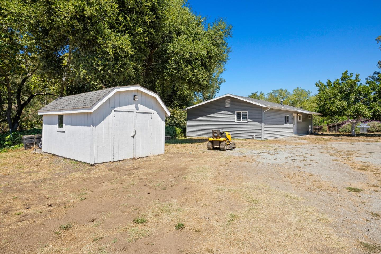 129 Browns Valley Road, Unit A Watsonville, CA 95076 - Photo 20 of 45 a white house with a big yard and large trees